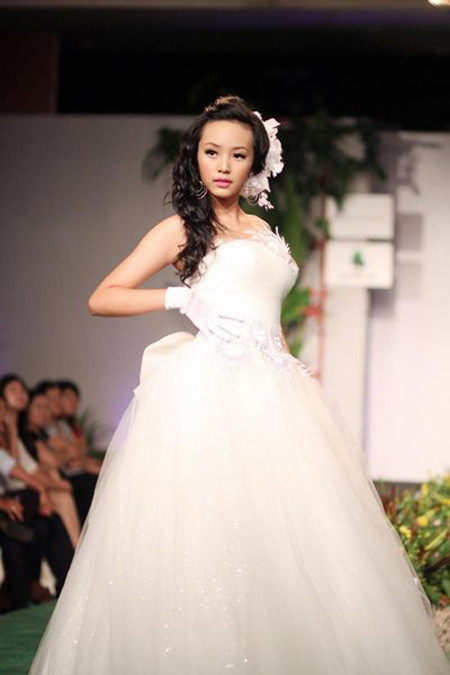 Vẫn là nàng dâu trên sàn catwalk, nhưng khi đổi kiểu tóc từ ngắn tinh nghịch sang xoăn dài điệu đà, diện mạo của Bảo Trân trở nên khác hẳn. Hot girl Sài Thành tạo ấn tượng cô dâu hiện đại, kiêu kỳ. Đối với các bạn nữ ưa thích vẻ đẹp ngọt ngào, sang trọng, hoàn toàn có thể tham khảo style váy cưới này.