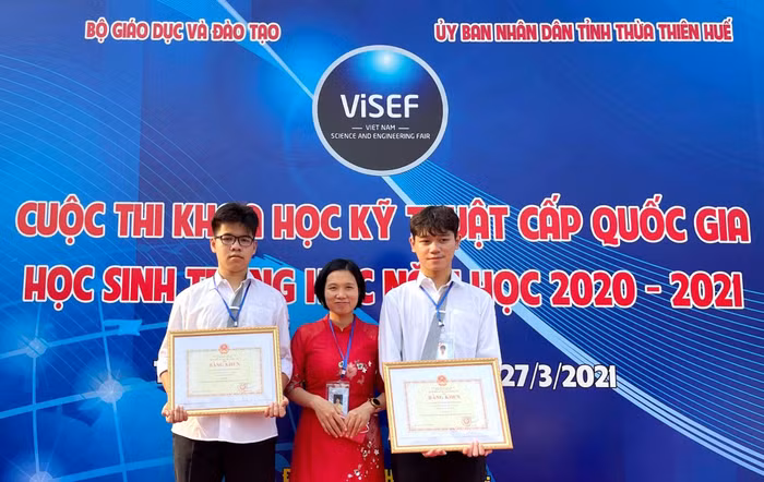Giáo viên hướng dẫn Lê Thị Thúy và hai bạn học sinh Đỗ Gia Khánh (bên phải ảnh) và Ngô Gia Bảo - Trường Trung học phổ thông Chuyên Hà Nội - Amsterdam đạt giải Nhì cuộc thi Khoa học Kĩ thuật cấp Quốc gia học sinh Trung học năm 2021 vừa được tổ chức tại Thừa Thiên - Huế. Ảnh: Nhân vật cung cấp.