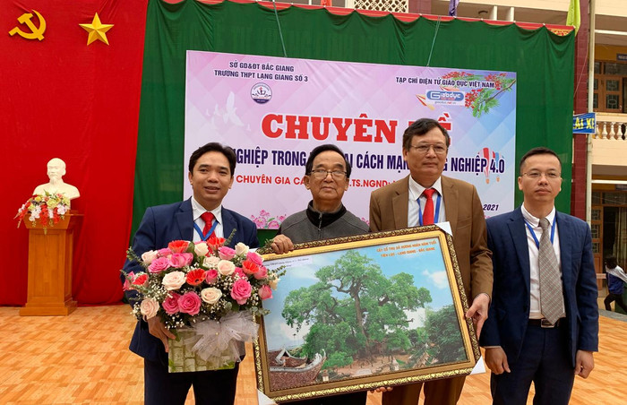 (Từ trái qua phải) Thầy Nguyễn Huy Nghĩa - Phó hiệu trưởng, Giáo sư Nguyễn Lân Dũng, thầy Nguyễn Văn Nam - Hiệu trưởng và thầy Trương Văn Giáp - Phó hiệu trưởng, tặng hoa, chụp ảnh lưu niệm với Giáo sư Nguyễn Lân Dũng. Ảnh: Tùng Dương.