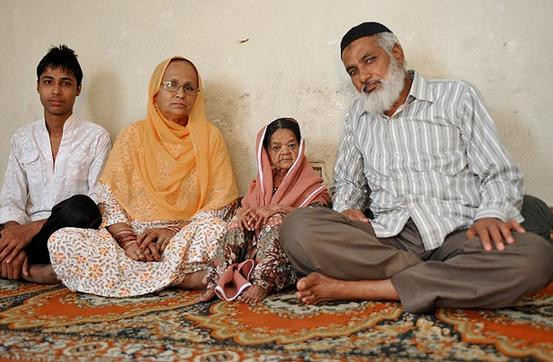 Cụ già Zeenat Bi trong vòng tay che chở của các thành viên gia đình bác sĩ Abrar Khan. Ảnh. The Sun.