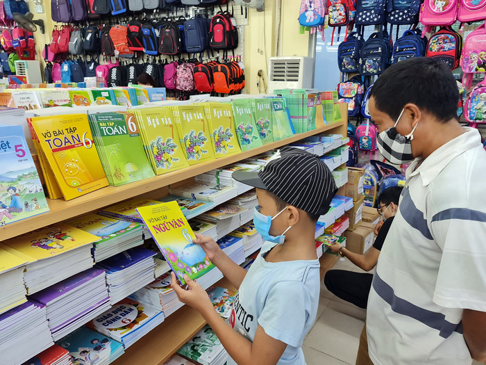 Anh P. cùng con trai lặn lội hơn 20 km ra trung tâm thành phố tìm mua sách giáo khoa lớp 6 nhưng không mua được (Ảnh: Lã Tiến) Anh P. cùng con trai lặn lội hơn 20 km ra trung tâm thành phố tìm mua sách giáo khoa lớp 6 nhưng không mua được (Ảnh: Lã Tiến)