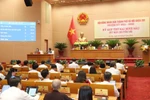 Giám đốc Sở Tài chính Hà Nội Nguyễn Xuân Lưu trình bày Tờ trình. Ảnh: hanoi.gov.vn.