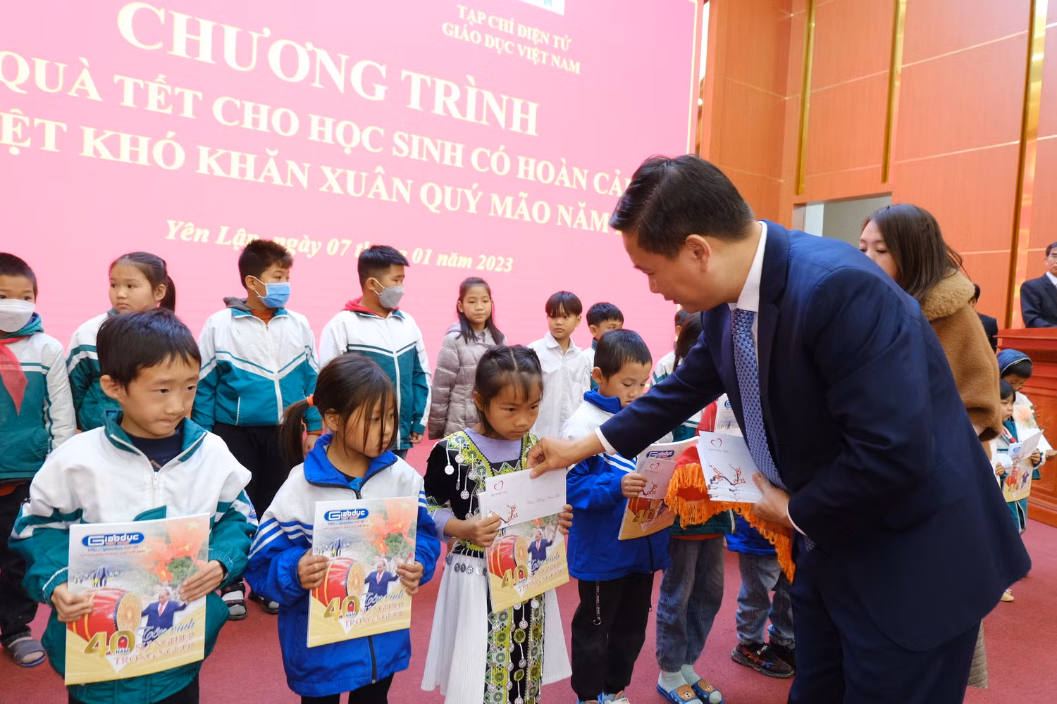 Em học sinh người dân tộc Mông được nhận quà từ Tổng Biên tập Nguyễn Tiến Bình.