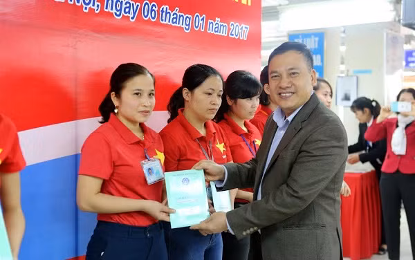 Ông Chu Minh Tộ - Trưởng ban Sổ, thẻ (Bảo hiểm xã hội Việt Nam) trao sổ Bảo hiểm xã hội cho người lao động.
