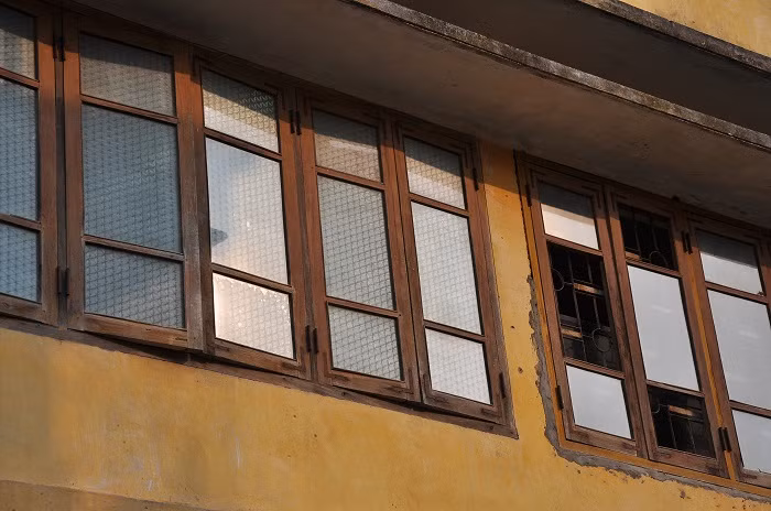 Phần lớp các của kính phía sau trường - nơi giáp với nhà dân được dán giấy kính màu trong suốt trước ngày thi vào lớp 10.