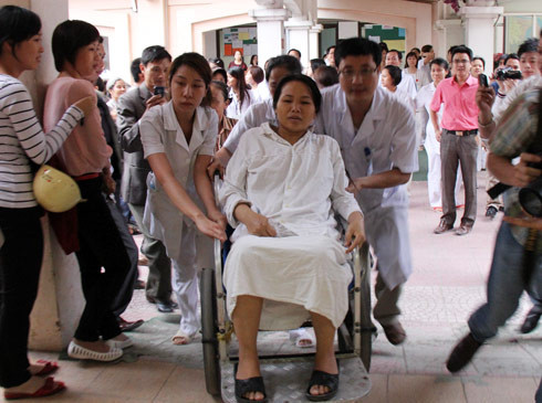 Chờ đợi lâu, chị Thơm ngất xỉu và được bác sĩ đưa lên xe đẩy. (ảnh: VNE) Chờ đợi lâu, chị Thơm ngất xỉu và được bác sĩ đưa lên xe đẩy. (ảnh: VNE)