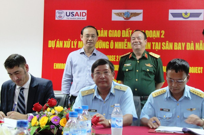 Cơ quan chức năng hai bên ký kết bàn giao 12,7 hecta đất đã qua xử lý, tẩy độc dioxin. Ảnh: TT