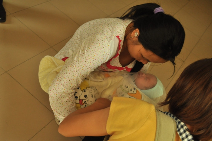 Chị Thơm che khăn cho cháu