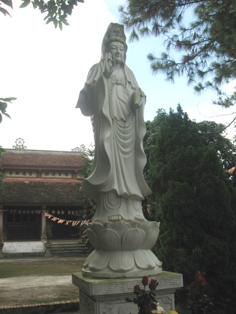 Tượng Phật Quan Thế Âm Bồ Tát được tạc bằng đá sừng sững trước lối lên chùa Tượng Phật Quan Thế Âm Bồ Tát được tạc bằng đá sừng sững trước lối lên chùa