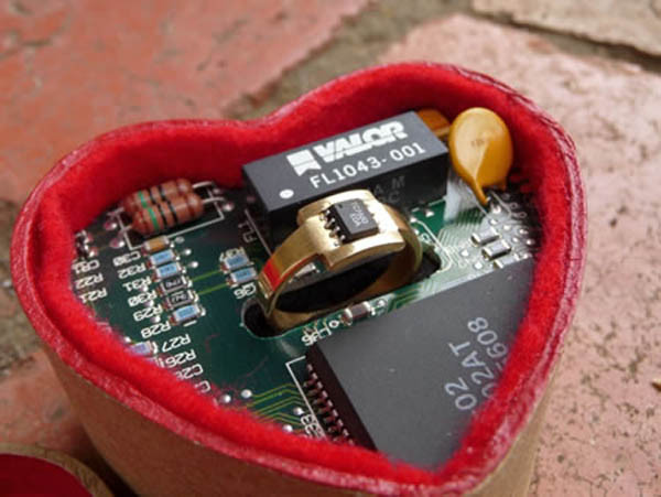 8. Nhẫn công nghệ Geeky ring Mặt chiếc nhẫn này được đặt vào một con chip rất nhỏ và để trong một bảng mạch. Mặc dù chiếc nhẫn không hút được hồn những chị em yêu thích kim cương hay các loại đá đắt tiền song không thể phủ nhận sự sáng tạo và niềm đam mê công nghệ trong thiết kế này. chiếc nhẫn trông thật lãng mạn với hộp đựng hình trái tim màu đỏ và chắc chắn đây sẽ là chiếc nhẫn cưới hoàn hảo dành cho người vợ yêu của bạn. 8. Nhẫn công nghệ Geeky ring Mặt chiếc nhẫn này được đặt vào một con chip rất nhỏ và để trong một bảng mạch. Mặc dù chiếc nhẫn không hút được hồn những chị em yêu thích kim cương hay các loại đá đắt tiền song không thể phủ nhận sự sáng tạo và niềm đam mê công nghệ trong thiết kế này. chiếc nhẫn trông thật lãng mạn với hộp đựng hình trái tim màu đỏ và chắc chắn đây sẽ là chiếc nhẫn cưới hoàn hảo dành cho người vợ yêu của bạn.