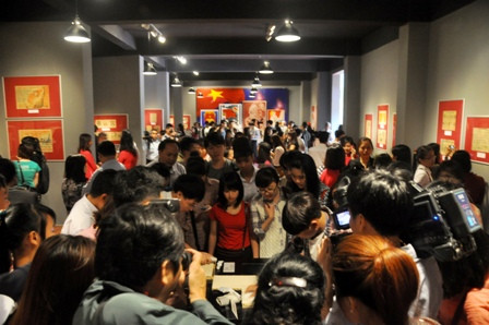 Phòng trưng bày đông kín người xem.