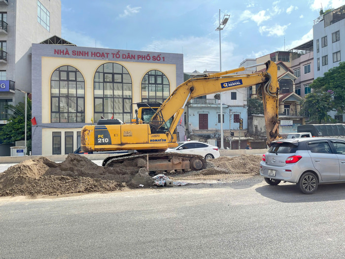 Máy xúc thực hiện việc san lấp và dọn dẹp vật liệu để công nhân thi công dải phân cách giữa. GDVN_21.jpg