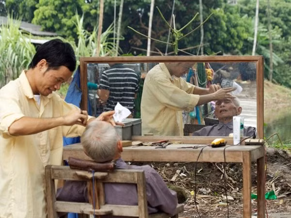 Cắt tóc, cạo râu ở vỉa hè luôn được cánh mày râu ở Việt Nam yêu thích.