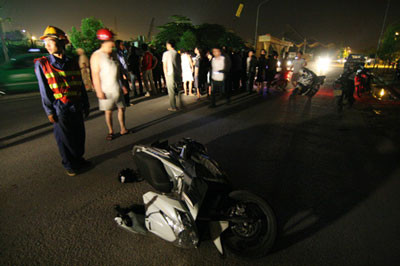 Chiếc xe máy nằm cách nạn nhân khoảng 10 m, người đàn ông nằm bất tỉnh trên đường được đưa đi cấp cứu ngay sau đó. Ảnh. L.H.