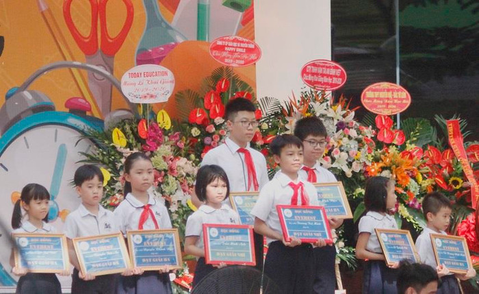 Các em học sinh nhận học bổng của nhà trường vì có thành tích học tập xuất sắc (ảnh Trinh Phúc).