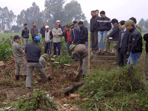 Người dân giám sát việc lấp lại ngôi mộ đã bị đào trộm