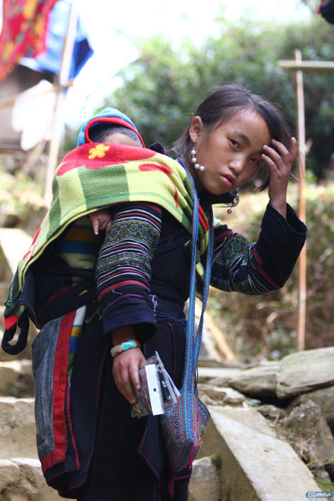 Cậu nhóc được địu ở phía sau lưng mẹ có vẻ đã ngủ ngon lành.