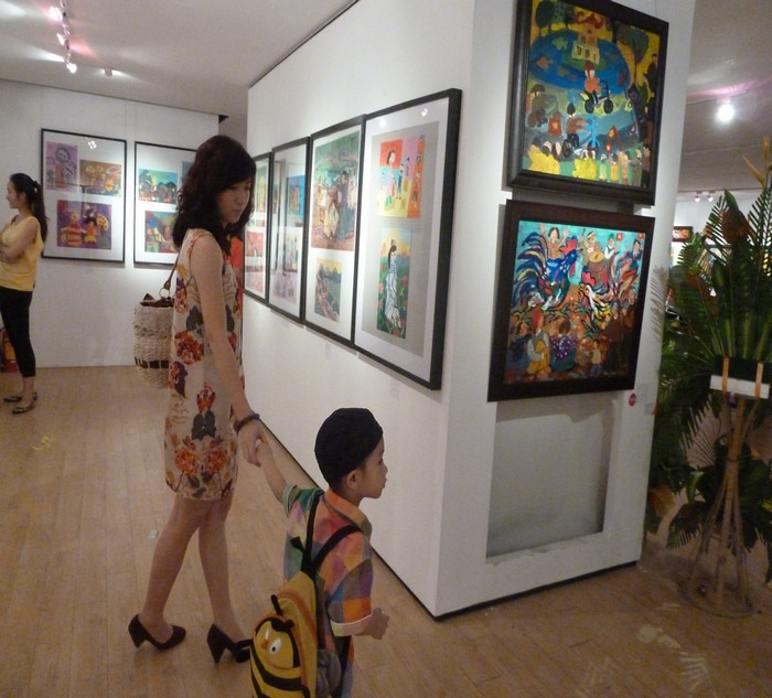 Cậu nhóc này lôi bằng được mẹ ra ngắm tranh của các bạn. Cậu nhóc này lôi bằng được mẹ ra ngắm tranh của các bạn.