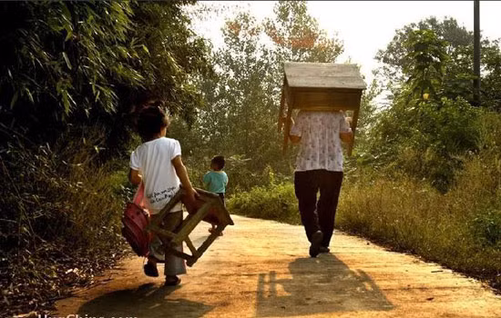 Phụ huynh và học sinh nặng nhọc vác bàn đến trường.