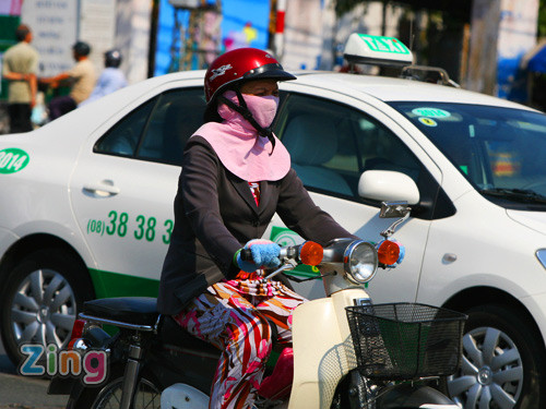 Khăn trùm kín mặt, áo khoác dày, găng tay len... tất cả tưởng như là phục trang của người dân Hà Nội trong mùa đông... Nhưng không, đây là bộ đồ của người Sài Gòn dưới cái nóng hơn 39 độ. Ảnh: Zing Khăn trùm kín mặt, áo khoác dày, găng tay len... tất cả tưởng như là phục trang của người dân Hà Nội trong mùa đông... Nhưng không, đây là bộ đồ của người Sài Gòn dưới cái nóng hơn 39 độ. Ảnh: Zing