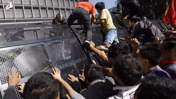 Đám đông cố tình vượt hàng rào do cảnh sát cơ động dựng lên để lao về phía Đại sứ quán Nhật Bản