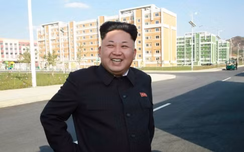Ảnh chụp Kim Jong-un cười rạng rỡ khi đi thăm khu chung cư mới xây dựng, nhưng chỉ chụp từ thắt lưng trở lên giấu đi chiếc gậy.