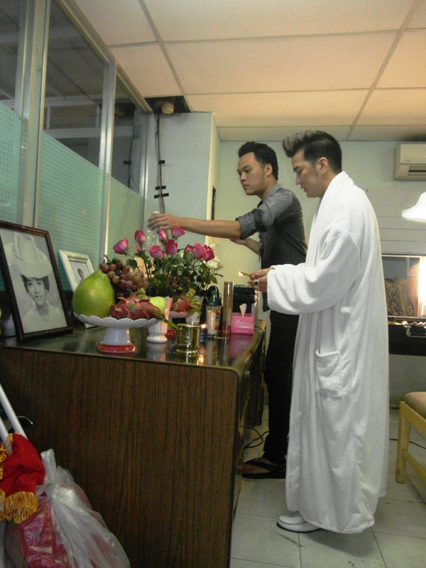 Nơi đây có một bàn thờ nữa. Mr Đàm đã“thỉnh” bàn thờ NSƯT Thanh Nga từ nhà mình vào sân khấu Lan Anh, trong hai ngày liveshhow Số phận diễn ra (21&22/7). Trong ảnh: Một nhân viên thân tín đang giúp Mr Đàm thắp hương…