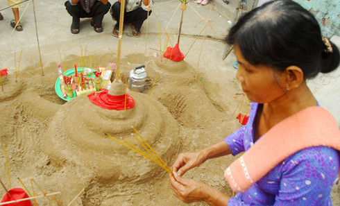 Xây núi cát, cúng bái để chuộc tội lỗi suốt năm qua.