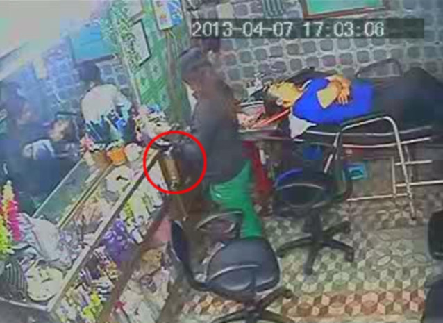 Giả vờ soi gương chải tóc, trong khi đó một tay thò xuống kéo ngăn tủ.