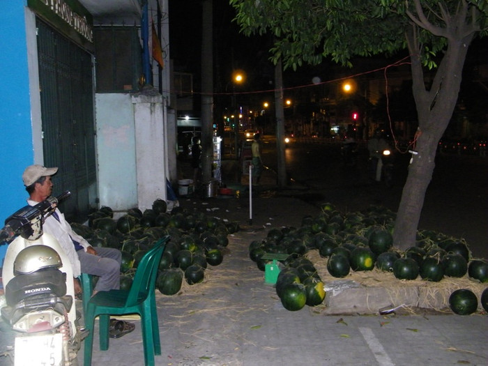 Họ là một phụ nữ từ quê ra thành phố hay một người đàn ông sinh trưởng tại TP.HCM…. nhưng đều có một điểm chung: Vất vả mưu sinh, kiếm thêm chút tiền cho gia đình trong những ngày tết. 1 giờ sáng của ngày 28 tết, ông Đức vẫn ngồi lặng lẽ bên đống dưa hấu của mình, trên vỉa hè con đường vắng Phan Đăng Lưu vắng hoe (Q.Phú Nhuận). Đây là những quả dưa ông trồng tại Bà Rịa – Vũng Tàu, mang vào Sài Gòn và đổ ra vỉa hè này để bán từ ngày 25 tết. Ông cười vui: “Tui phải thức canh, chứ không có nhiều thanh niên đi chơi khuya quậy phá, họ tấp xe vào ôm vài trái dưa là chuyện thường. Năm ngoái tui bị rồi nên kinh nghiệm lắm chú ạ”. Họ là một phụ nữ từ quê ra thành phố hay một người đàn ông sinh trưởng tại TP.HCM…. nhưng đều có một điểm chung: Vất vả mưu sinh, kiếm thêm chút tiền cho gia đình trong những ngày tết. 1 giờ sáng của ngày 28 tết, ông Đức vẫn ngồi lặng lẽ bên đống dưa hấu của mình, trên vỉa hè con đường vắng Phan Đăng Lưu vắng hoe (Q.Phú Nhuận). Đây là những quả dưa ông trồng tại Bà Rịa – Vũng Tàu, mang vào Sài Gòn và đổ ra vỉa hè này để bán từ ngày 25 tết. Ông cười vui: “Tui phải thức canh, chứ không có nhiều thanh niên đi chơi khuya quậy phá, họ tấp xe vào ôm vài trái dưa là chuyện thường. Năm ngoái tui bị rồi nên kinh nghiệm lắm chú ạ”.