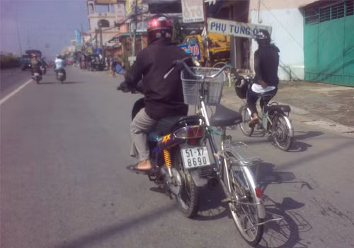 Chạy xe máy kéo theo xe đạp. Ảnh: Hà Ngọc Sang Chạy xe máy kéo theo xe đạp. Ảnh: Hà Ngọc Sang