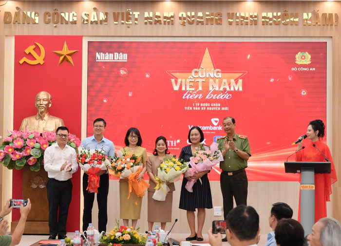 Ông Lê Quốc Minh - Ủy viên Ban Chấp hành Trung ương Đảng, Tổng Biên tập Báo Nhân Dân, Phó Trưởng Ban Tuyên giáo và Dân vận Trung ương, Chủ tịch Hội Nhà báo Việt Nam (bên trái) và Thiếu tướng Lê Hồng Hiệp - Phó Cục trưởng Cục Công tác chính trị Bộ Công an (bên phải) tặng hoa cho đại diện thương hiệu đồng hành Vietcombank - bà Đoàn Hồng Nhung, Thành viên Ban Điều hành, Giám đốc Khối Bán lẻ (thứ 3 từ trái sang) cùng các nhà tài trợ khác. 20250811-lhq-hopbaocungvietnamtienbuoc-82.jpg