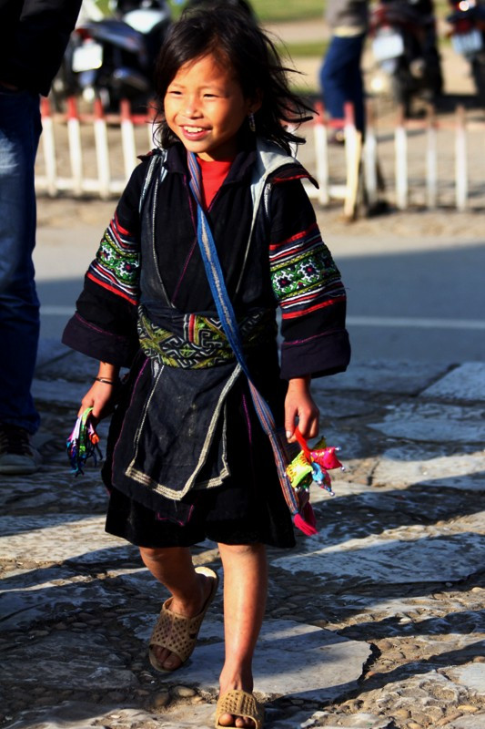 Một em bé tay cầm những món quà lưu niệm làm bằng tay chạy đi rao bán cho khách du lịch. Một em bé tay cầm những món quà lưu niệm làm bằng tay chạy đi rao bán cho khách du lịch.