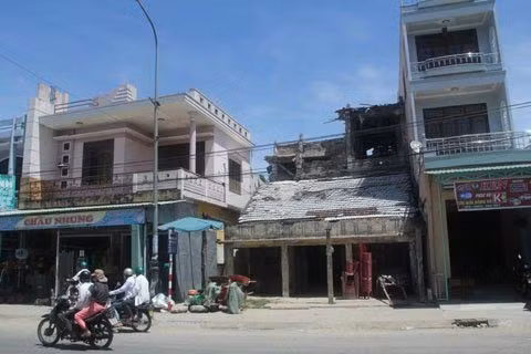 Ông làm đủ thứ nghề, trong đó nghề kéo hàng thuê nơi chợ Nam Phước này gắn bó với ông lâu dài nhất. Bước sang tuổi 80, sức đã gần tàn nhưng dường như ông chẳng muốn rời xa chiếc xe kéo nặng nề và ọc ạch ấy. Điều tâm niệm suốt cuộc đời lão tỷ phú Hai Hộ được gói gọn một câu: “Ăn để sống, chứ không phải sống để ăn…”. Đây là điều lão tỷ phú đặt ra cho riêng mình và ông cứ sống đúng như vậy. Một năm ông chỉ đi chợ hai lần để mua thịt cá đó là tết và khi có giỗ. Ngày thường, ông chỉ ăn cơm với rau dưa, muối mắm, tối thường ăn hủ tiểu của cô chủ thuê đất nhà ông cho. Ảnh: Ngôi nhà ông Hộ (giữa) ở ngay trung tâm thị trấn sầm uất.