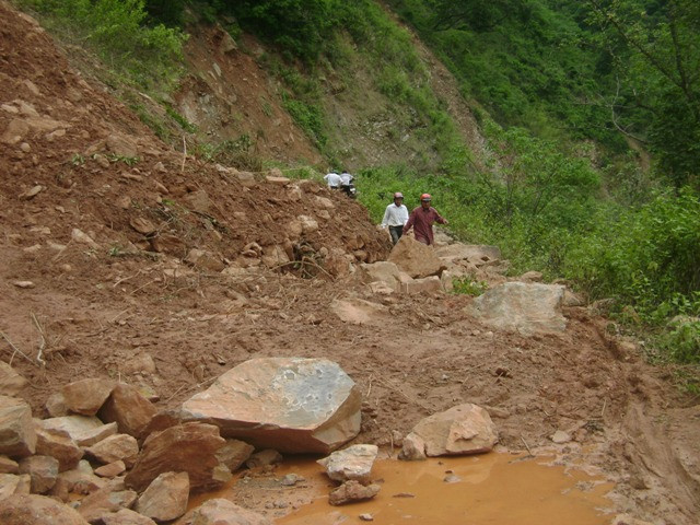 Đất đá sạt lở ngổn ngang xuống lòng đường, chắn ngang hết lối đi Đất đá sạt lở ngổn ngang xuống lòng đường, chắn ngang hết lối đi