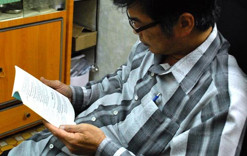 Bác sĩ Lê Đức Ban đang xem lại tài liệu nói về màu mắt