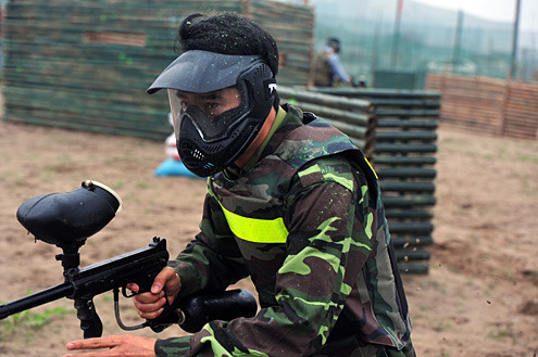 Một người bị đạn sơn bắn dính đầy đầu tóc và trang phục.