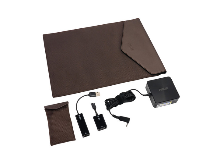 Phụ kiện Asus bán kèm theo máy, bao gồm một bao da lớn, cục sạc, adapter chuyển đổi mini VGA ra cổng VGA, adapter USB ra cổng LAN, túi da đựng đồ sạc