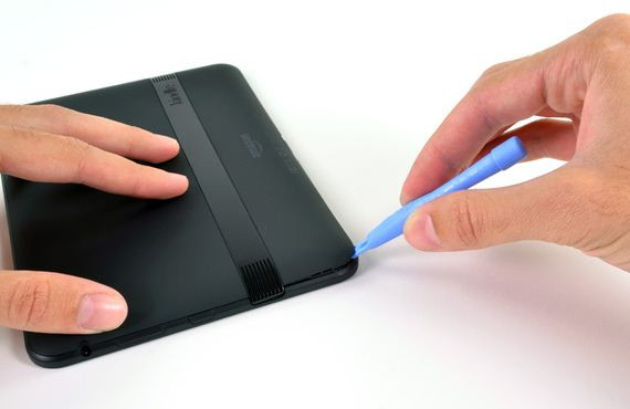 Dùng dụng cụ để mở nắp sau của máy.