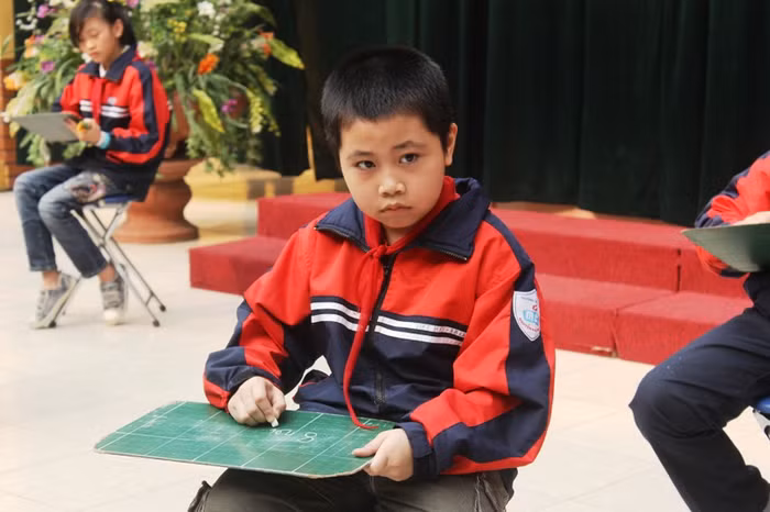 Một thí sinh đang suy nghĩ về câu hỏi và phân vân chưa tìm đúng câu trả lời.