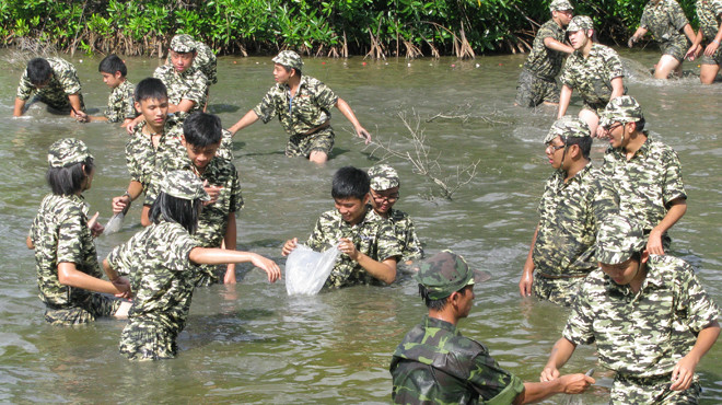 Học viên trải nghiệm kỹ năng sinh tồn của lính đặc công xưa bằng việc đánh lội đầm bắt cá - Ảnh: Q.LINH Học viên trải nghiệm kỹ năng sinh tồn của lính đặc công xưa bằng việc đánh lội đầm bắt cá - Ảnh: Q.LINH