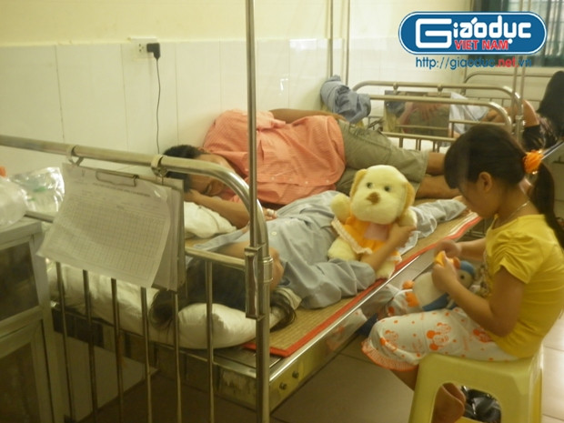 Cháu H đang nằm điều trị trong bệnh viện(người nằm trên giường bệnh), hiện tại sức khỏe cháu đang dần ổn định