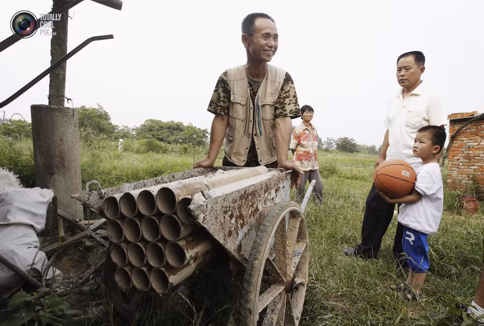 Dương Hữu Đức, một nông dân ở Vũ Hán, tỉnh Hồ Bắc và chiếc súng đại bác có một không hai của mình. Ông đã chế tạo trên chiếc xe cút kít, dùng để đối phó với lực lượng cưỡng chế giải phóng mặt bằng khi gia đình ông chưa đồng ý phương án đền bù.