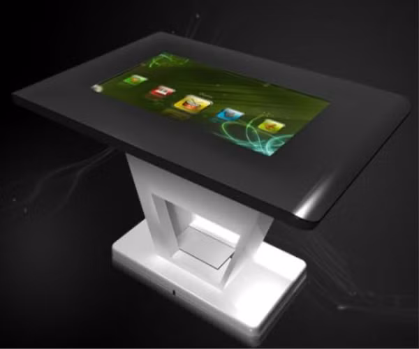 1. Bàn cảm ứng MagixTouch mỏng nhất thế giới Công ty TouchMagix Media rất tự hào khi cho ra đời chiếc bàn cảm ứng mỏng nhất thế giới MagixTouch.Chiếc bàn này tiêu ít hơn 60% điện năng so với những chiếc máy tính để bàn khác nhưng vẫn mang đến hiệu quả đáng nể. Sản phẩm này đi kèm với một bộ phần mềm tùy chọn đơn giản với có 40 điểm cảm ứng cùng lúc, tốc độ quét là 50 khung hình trong một giây và hoạt động dựa trên hệ điều hành Apple Mac Mini. Các thông số kĩ thuật của MagixTouch gồm ổ đĩa 350 GB, RAM 4 GB và bộ xử lý đồ họa 9400 M. Ngoài ra còn có 4 cổng USB 2.0, Bluetooth, Wi-Fi và Ethernet. Với rất nhiều tính năng hữu dụng, chiếc bàn cảm ứng này rất phù hợp để đặt ở khu mua sắm, bệnh viện hay nhà riêng. 1. Bàn cảm ứng MagixTouch mỏng nhất thế giới Công ty TouchMagix Media rất tự hào khi cho ra đời chiếc bàn cảm ứng mỏng nhất thế giới MagixTouch.Chiếc bàn này tiêu ít hơn 60% điện năng so với những chiếc máy tính để bàn khác nhưng vẫn mang đến hiệu quả đáng nể. Sản phẩm này đi kèm với một bộ phần mềm tùy chọn đơn giản với có 40 điểm cảm ứng cùng lúc, tốc độ quét là 50 khung hình trong một giây và hoạt động dựa trên hệ điều hành Apple Mac Mini. Các thông số kĩ thuật của MagixTouch gồm ổ đĩa 350 GB, RAM 4 GB và bộ xử lý đồ họa 9400 M. Ngoài ra còn có 4 cổng USB 2.0, Bluetooth, Wi-Fi và Ethernet. Với rất nhiều tính năng hữu dụng, chiếc bàn cảm ứng này rất phù hợp để đặt ở khu mua sắm, bệnh viện hay nhà riêng.