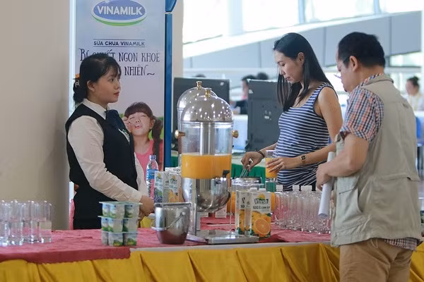 Các phóng viên trong và ngoài nước tham quan gian hàng trưng bày sản phẩm Vinamilk tại Trung tâm báo chí APEC tại Đà Nẵng (Ảnh: Xuân Phú)