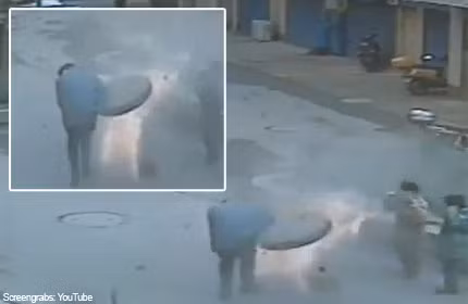 Nắp cống phụt lên không trung ngay sau khi người đàn ông Trung Quốc ném pháo sáng xuống bên dưới